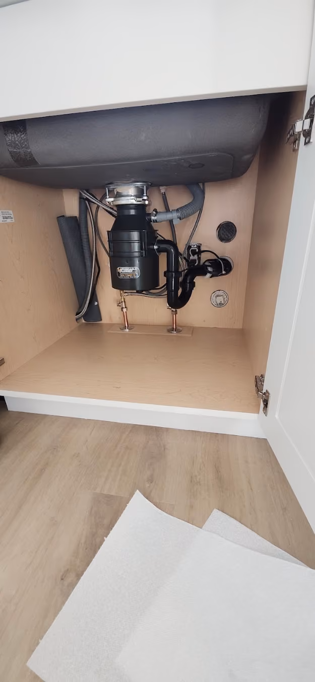 A new garbage disposal under a sink
