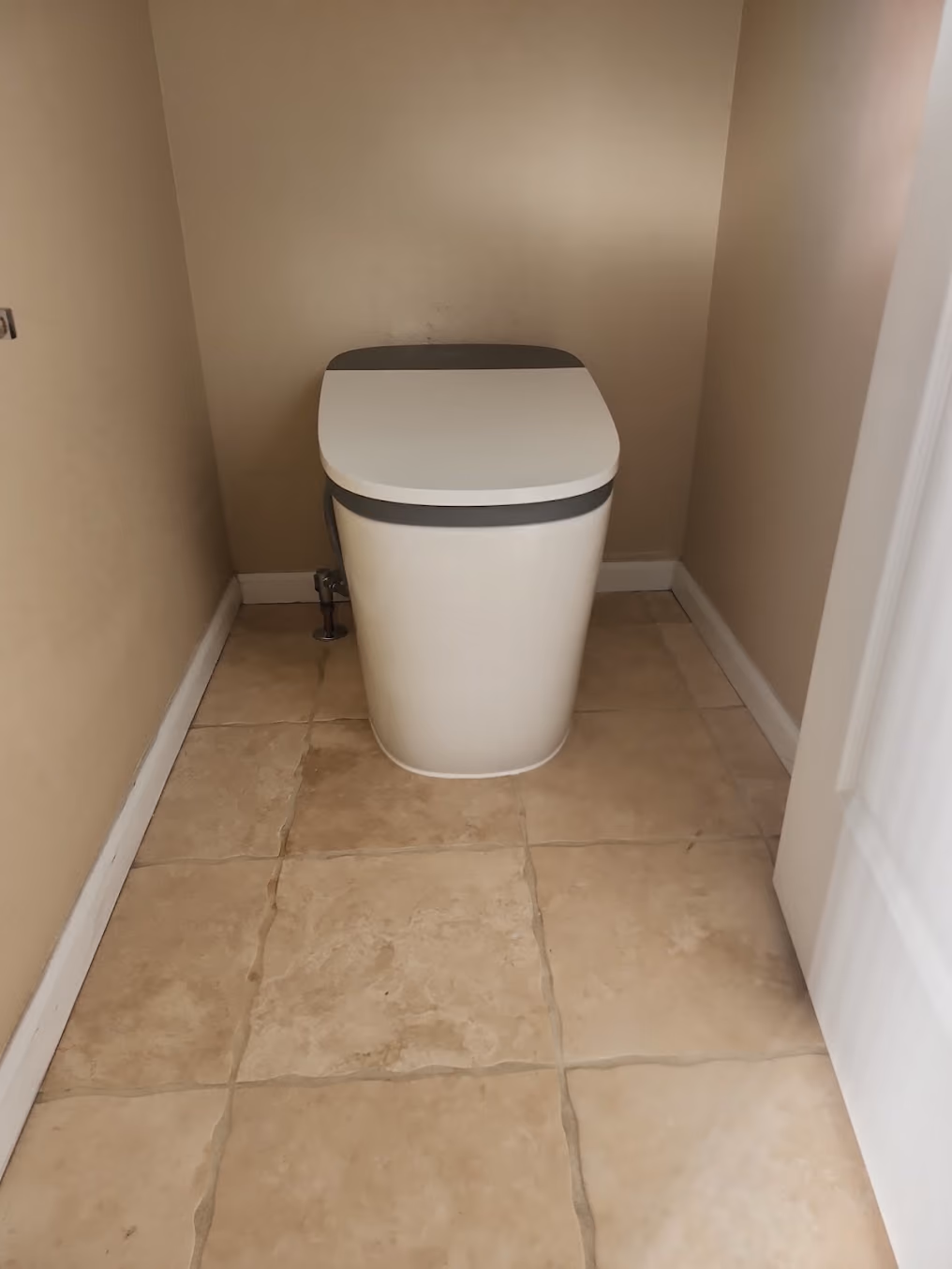 A smart toilet in a tiled bathroom