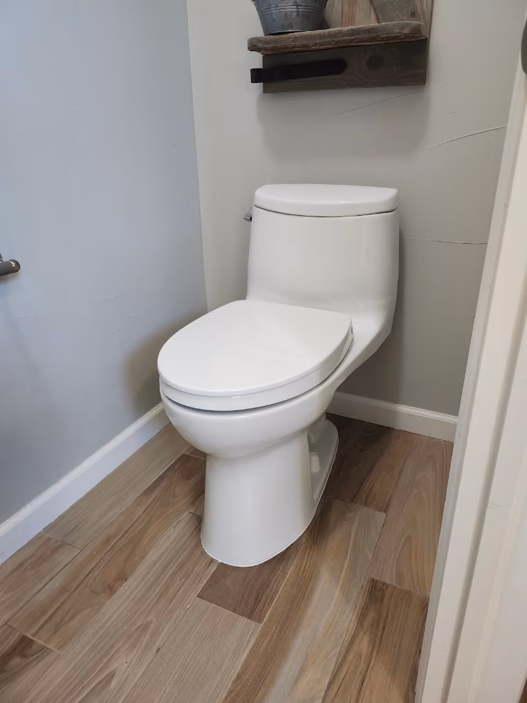 A new one-piece toilet in a small bathroom