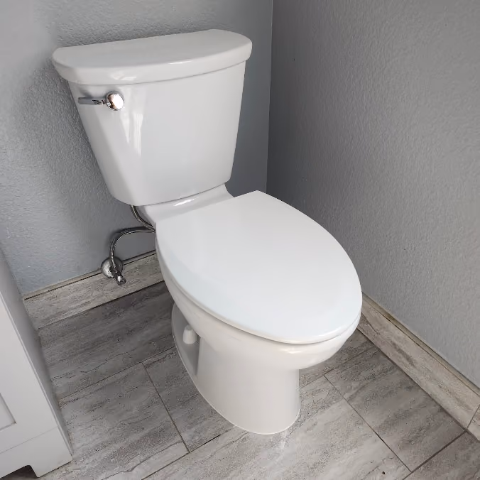 A new two-piece toilet with a new shut-off valve