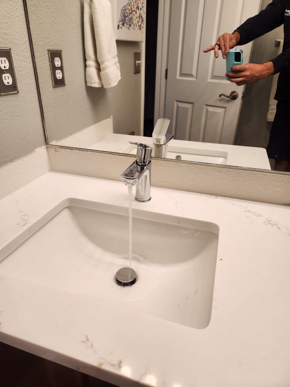 A modern bathroom faucet over an undermount sink