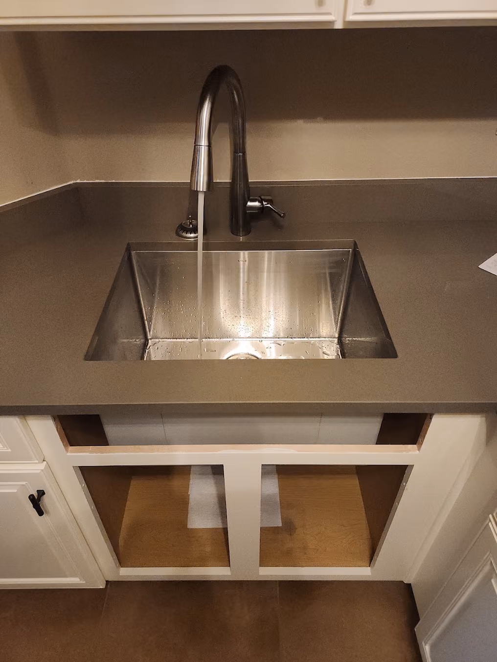 A stainless bar sink with a new faucet
