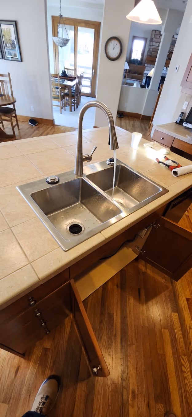 A kitchen faucet over a double stainless sink