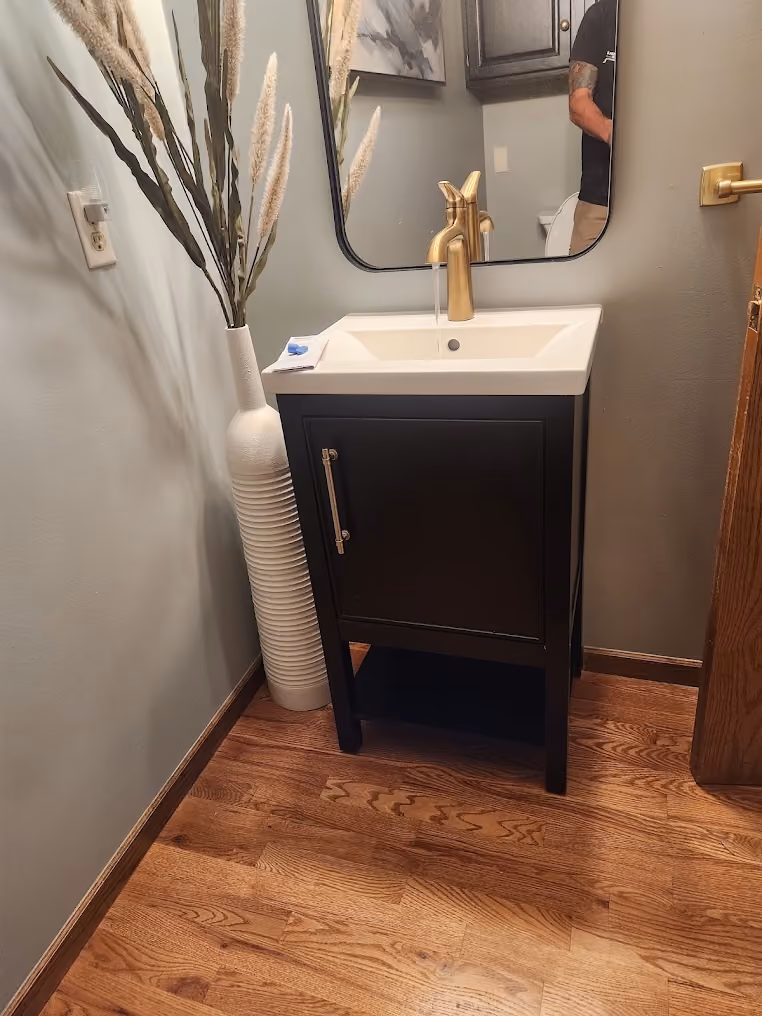 A small vanity with a brass faucet