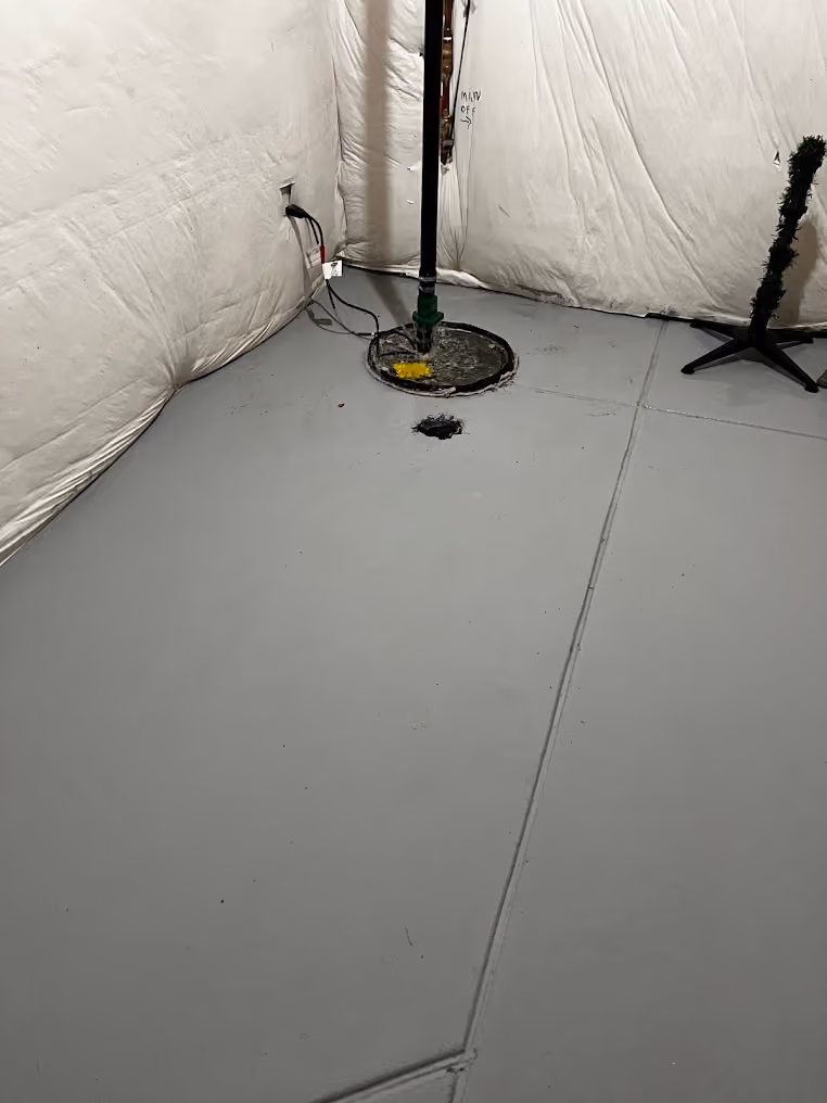 A new sump pump in a basement pit