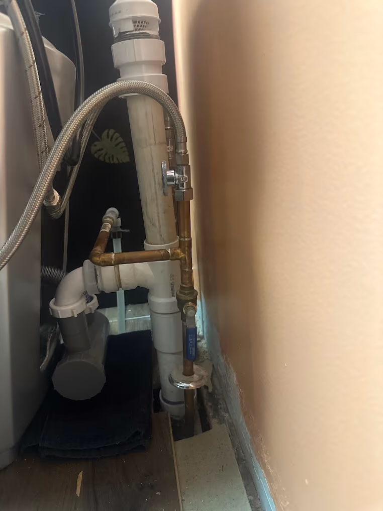 New shut-off valves and supply lines under a sink