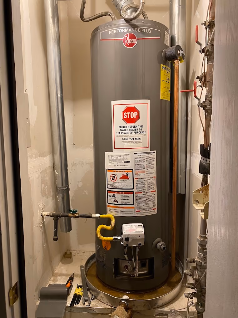 A water heater with its code labels and a new shut-off valve
