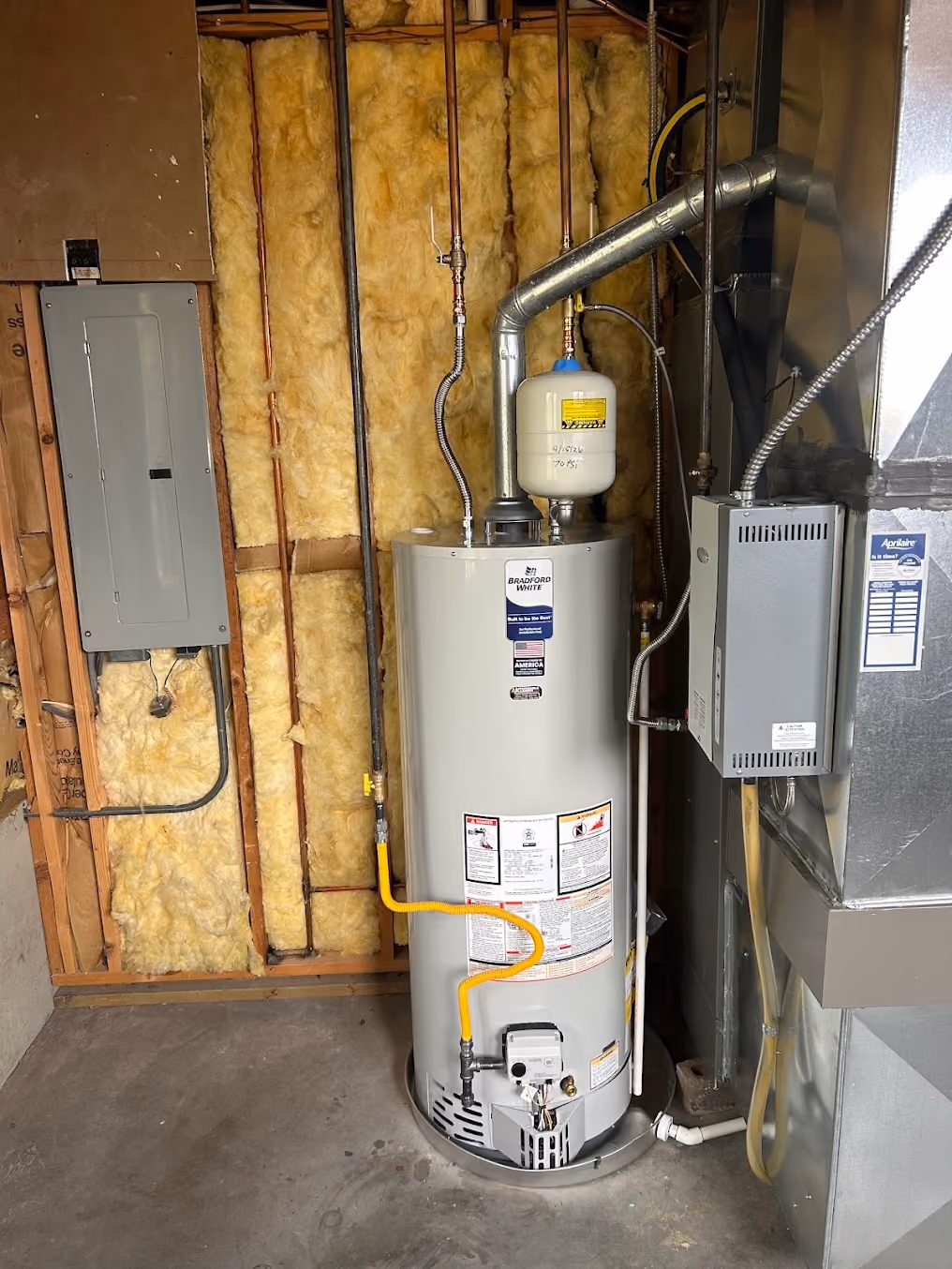 A new gas water heater in a basement utility room